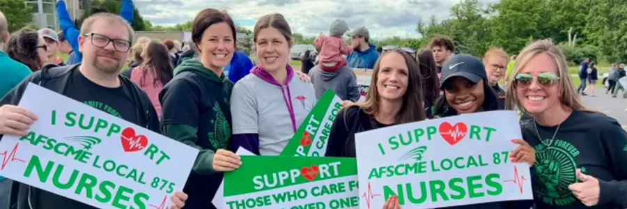 Photo of several different health care workers holding signs that say "I support AFSCME Local 875 Nurse" and "Support Those Who Care for Your Loved Ones"